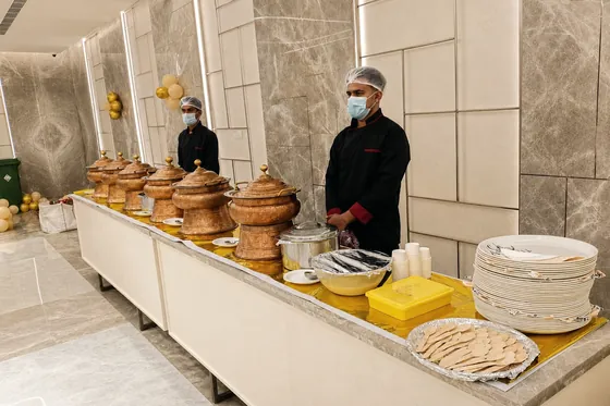 Freshly cooked curries in copper and steel serving pots.