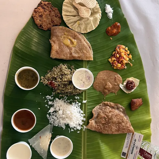 South Indian breakfast-style dishes arranged on banana leaves.