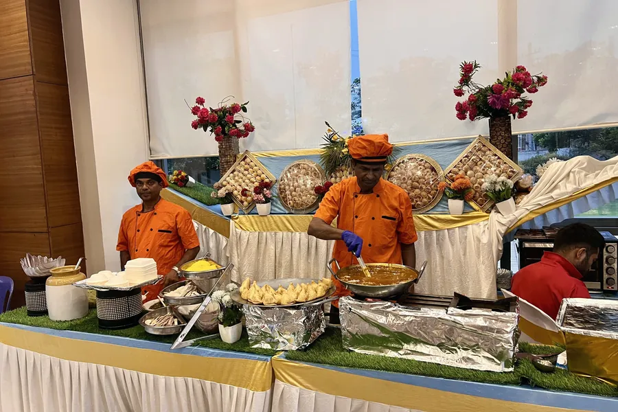 Corporate event catering counters and service team.